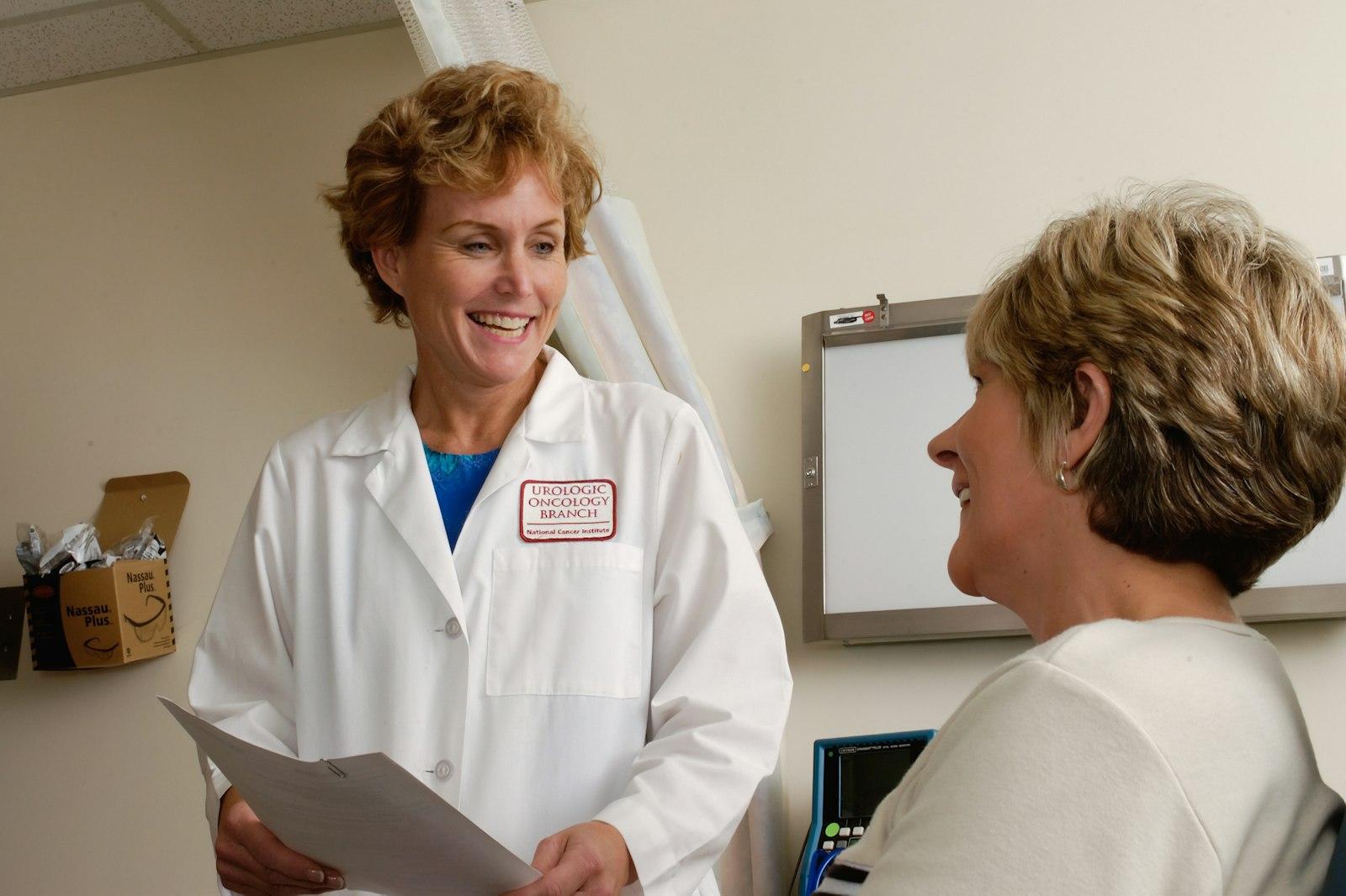 Senior compliance director reviewing customized safety binders with a practice manager in Physician Offices, Dental Clinics & Labs